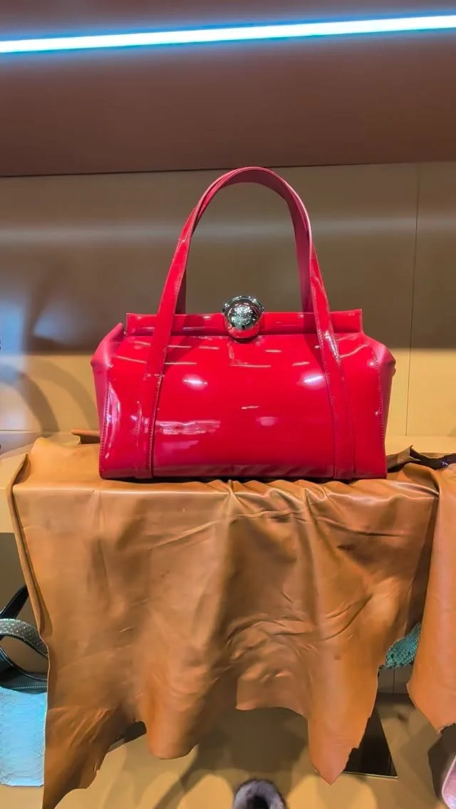 Glossy red structured leather handbag